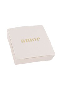 Scatola quadrata, di un rosa pallido e con una finitura liscia. Il coperchio presenta la parola "amor" in lettere dorate. Design minimalista con bordi arrotondati.