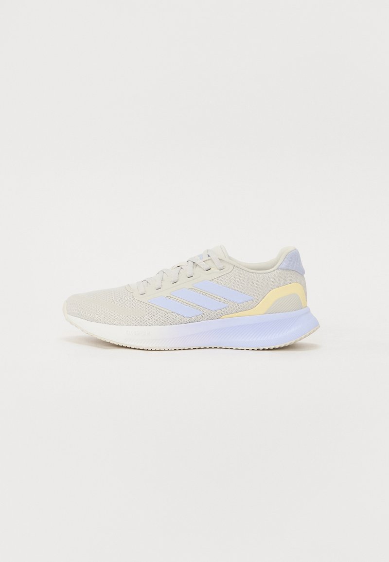Lace-up athletic shoe in light gray mesh with purple and yellow accents. Features a textured sole and padded collar for comfort.