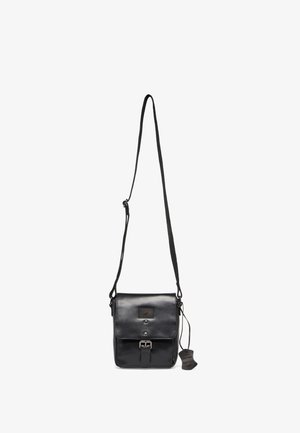 Black leather crossbody bag with adjustable strap, front buckle closure, and a leather tag hanging on the side.