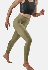 Green high-waisted leggings with a textured diamond pattern, paired with a black sports bra featuring gray accents and a fitted design.