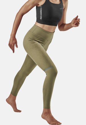 Green high-waisted leggings with a textured diamond pattern, paired with a black sports bra featuring gray accents and a fitted design.