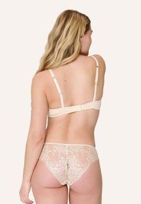 Beige blonde trusser med gennemsigtig blomsterdesign og matchende beige underwire bh, der har justerbare stropper og lukning med hægter.