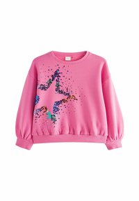 Roze dukserica dugih rukava, s rebrastim rubovima i velikim dizajnom zvijezde napravljenim od šarenih šljokica. Mekani materijal s ležernim krojem.