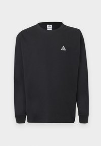 Μαύρο φούτερ με μακριά μανίκια και στρογγυλή λαιμόκοψη, με μικρό λευκό τριγωνικό λογότυπο ACG στο αριστερό στήθος και αντίστοιχη ετικέτα στο εσωτερικό του γιακά.