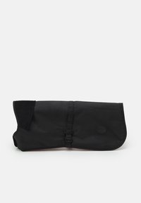 Sac noir avec une finition lisse et mate, présentant un design à rabat, une fermeture à bouton et des accents en velours côtelé sur un bord.