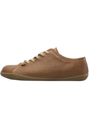 Brown leather lace-up sneaker with a smooth sole and minimalist design, shown from the side on a white background.