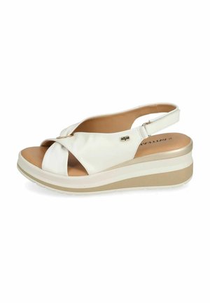 Sandalo zeppa bianco con cinturini incrociati, punta aperta, cinturino regolabile e suola platform beige imbottita.
