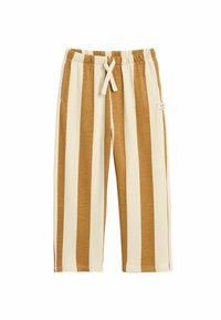 Lekki, w paski materiał spodni w odcieniach beżu i brązu. Posiada elastyczny pas, sznurek do regulacji i boczne kieszenie. Miękka tekstura i długość do kolan.