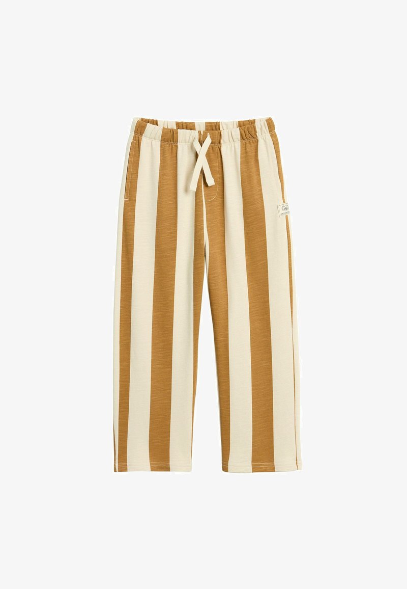 Lekki, w paski materiał spodni w odcieniach beżu i brązu. Posiada elastyczny pas, sznurek do regulacji i boczne kieszenie. Miękka tekstura i długość do kolan.