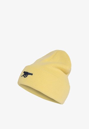 Weiche gelbe Strickmütze mit umgeschlagenem Bündchen und kleinem schwarzen, besticktem Kanonen-Logo an der Seite vor weißem Hintergrund.