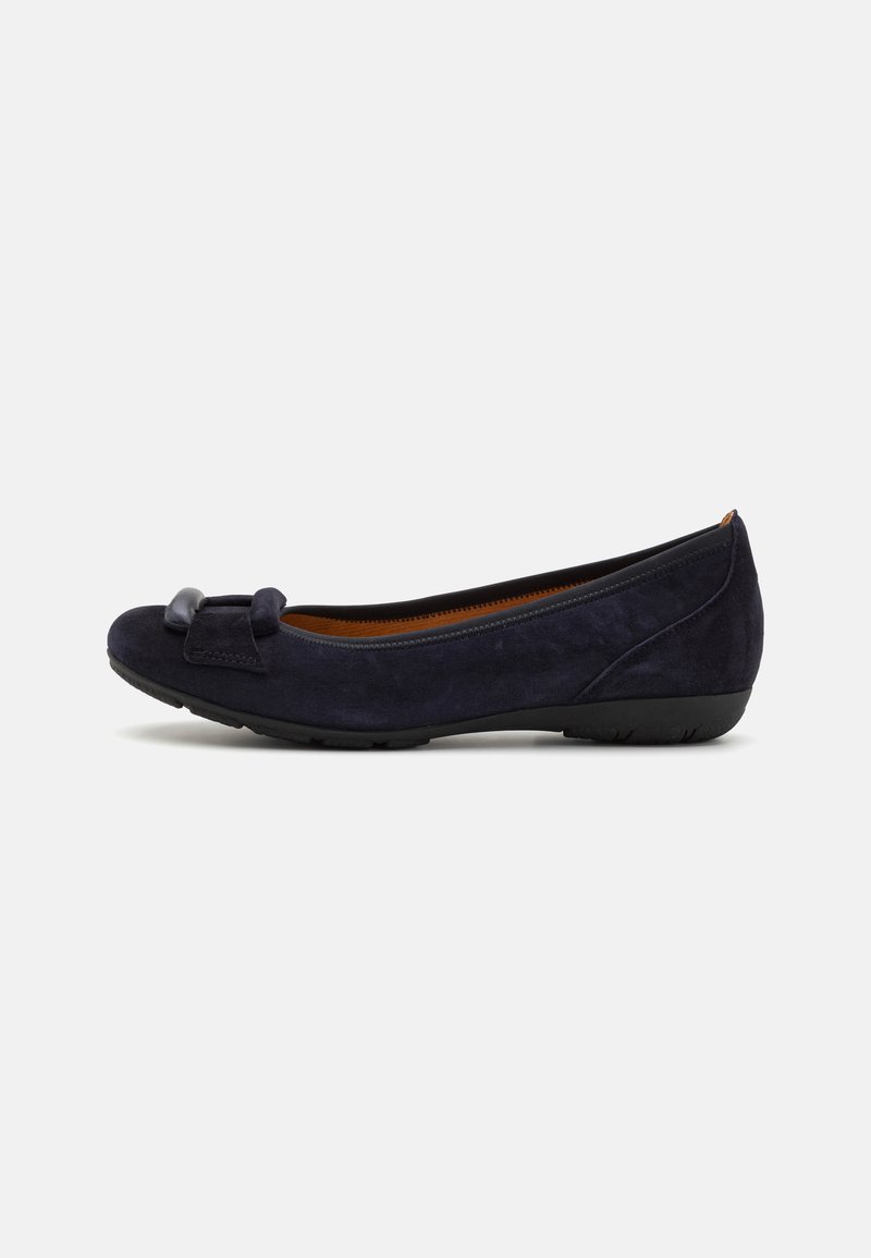Ballerine in camoscio blu navy con punta rotonda, caratterizzate da un piccolo fiocco decorativo e una suola in gomma nera flessibile. Texture complessiva liscia.