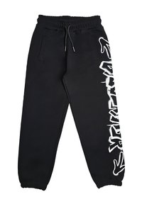 Pantaloni jogger neri con vita ed orli elasticizzati, tasche laterali e design testuale in stile graffiti bianco sulla gamba destra.