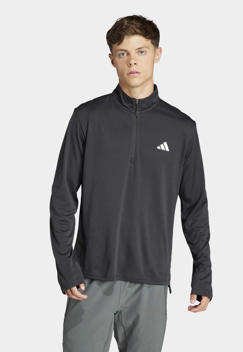 Schwarzes, langärmeliges Sportoberteil mit einem Viertel-Reißverschluss und Adidas-Logo. Hergestellt aus glattem, leichtem Material mit einem lockeren Schnitt und ohne Muster.