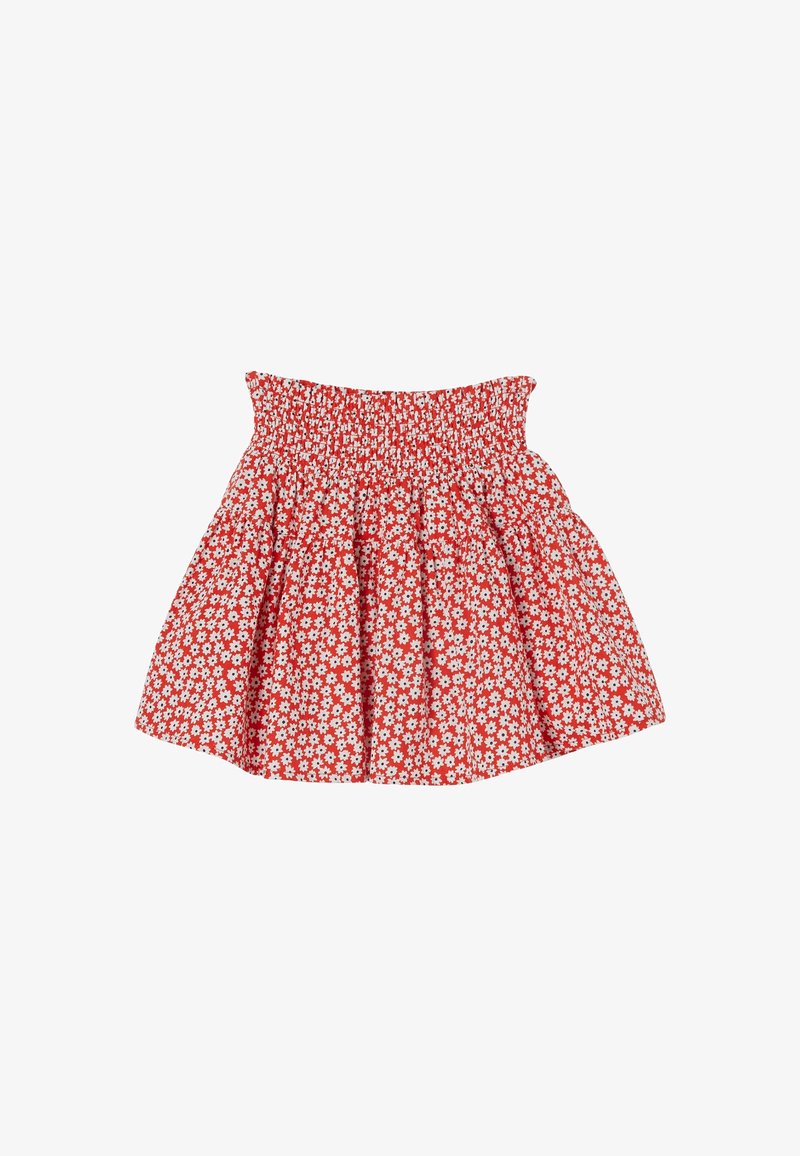 Jupe rouge avec un motif floral de marguerites blanches, taille froncée et ourlet évasé, posée à plat sur un fond blanc.