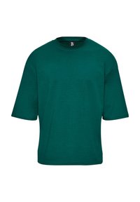Zöld, oversize póló, puha anyagból készült. Kerek nyakú és rövid ujjú, minimalista dizájnnal rendelkezik, látható minták nélkül.