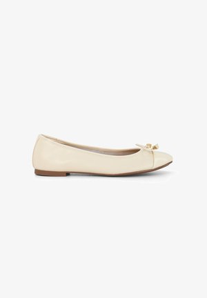 Beige patent leather ballet flat with a rounded toe, bow detail at the front, and a flat, brown sole. Smooth texture overall.