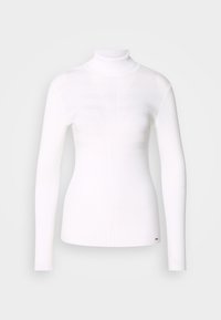 Pull à col roulé blanc, en tissu côtelé, avec manches longues et coupe slim, présentant un léger détail texturé sur le devant.