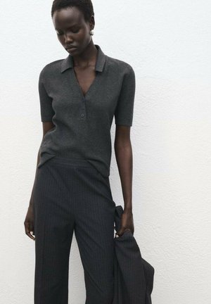 Dark gray short-sleeve polo top with a v-neck and three buttons, paired with dark pinstriped trousers. Smooth texture and fitted silhouette.