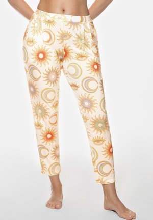 Light-colored elastic waistband pants featuring a sun and moon pattern in warm tones of orange and yellow, with a smooth texture and tapered design.