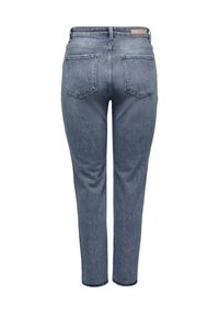 Modré džínové kalhoty s přiléhavým střihem, středním pasem, pěti kapsami a jemným vyblednutím. Tkanina má hladkou texturu.