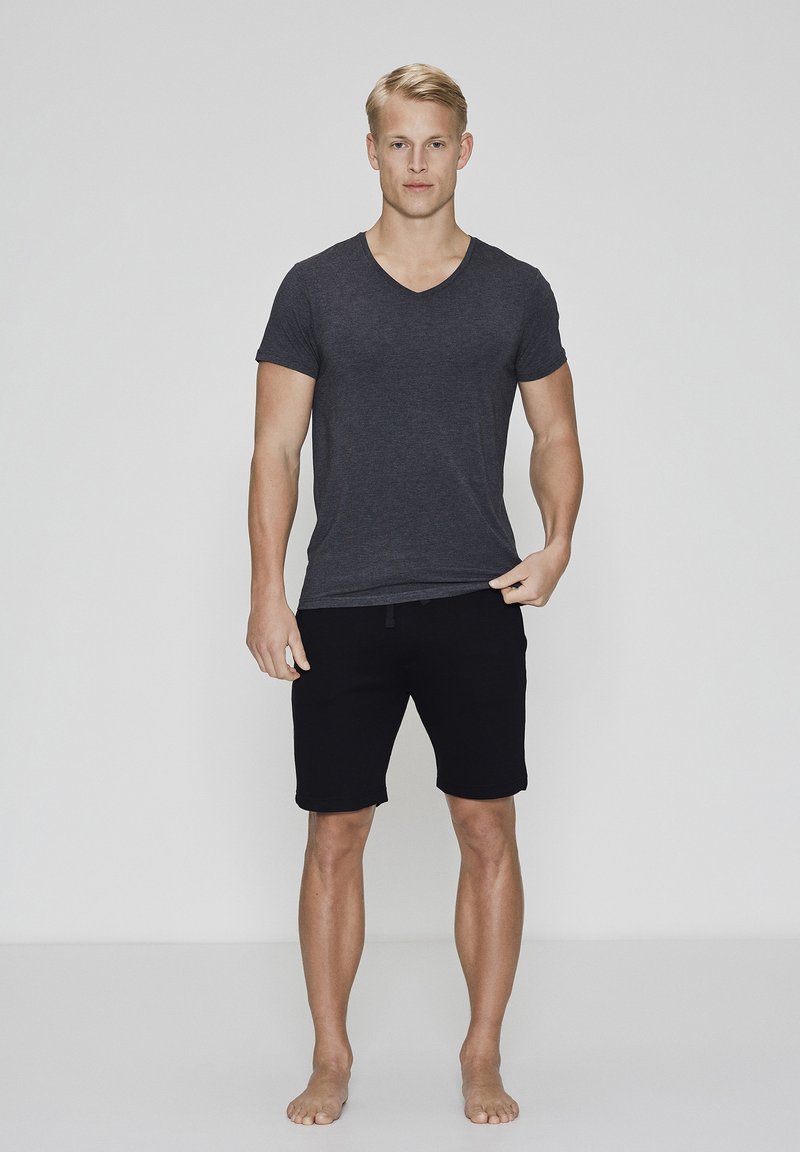 Black shorts and a dark gray v-neck t-shirt, both made of soft fabric. The shorts have an elastic waistband and a straight leg design.