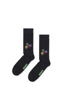 Chaussettes noires ornées de lettres colorées en blocs épelant "WASD" et du mot "HAPPY" en vert sur la semelle. Fabriquées en tissu doux et extensible.