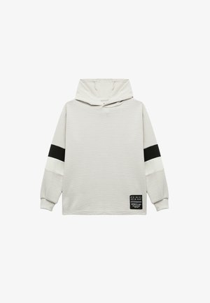 Lichtgrijze hoodie met zwart-witte gestreepte accenten. Ribbelstructuur en applicélabel aan de onderzijde. Ontspannen pasvorm.