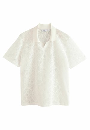 Polo bianca a manica corta con motivo a diamante in rilievo, colletto a contrasto in colore uniforme e vestibilità comoda.