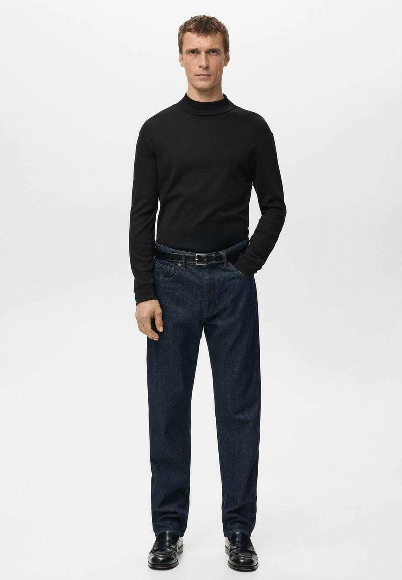 Black turtleneck sweater paired with dark blue jeans and black shoes, featuring a classic fit and minimalistic design. Simple and clean presentation.