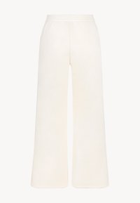 Brede, crème kleurige broek gemaakt van zachte stof. Kenmerkt een elastische tailleband en een gladde textuur zonder zichtbare patronen of hardware.