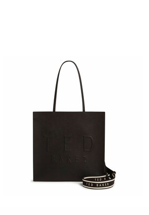 Bolso tote cuadrado negro con asas finas y logotipo en relieve "TED BAKER", acompañado de una correa negra y blanca de marca desmontable.