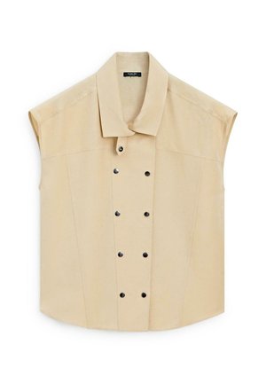 Beżowa kamizelka bez rękawów z podwójnym zapięciem na czarne zatrzaski, z szerokim kołnierzem i strukturalnymi szwami.