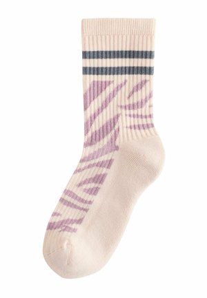 Beige ribbed socks featuring purple zebra stripes and two dark blue horizontal stripes at the top. Soft, knitted texture.