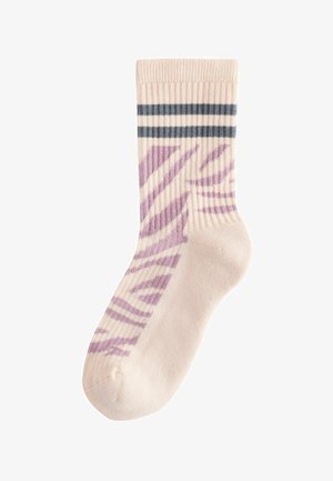Beige ribbed socks featuring purple zebra stripes and two dark blue horizontal stripes at the top. Soft, knitted texture.