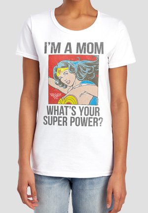 Person wearing white t-shirt with comic-style Wonder Woman image and text "I'm a mom, what's your super power?"