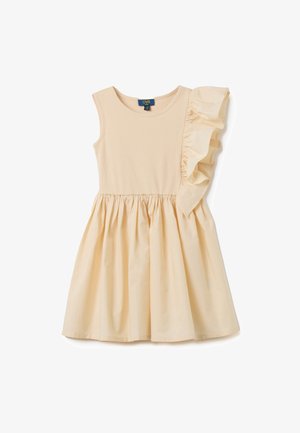 Helles beigefarbenes ärmelloses Kleid mit einem gerippten Oberteil, einem ausgestellten Rock und einem Rüschendetail an einer Schulter. 95 % Baumwolle, 5 % Elasthan.