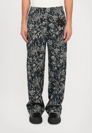 Black and white floral patterned pants with an elastic waistband and two side pockets, made from a lightweight fabric.
