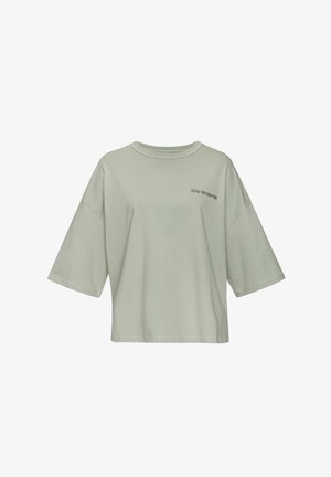 Light green oversized cotton t-shirt with short wide sleeves, ribbed crew neckline, and embroidered "CPH STUDIOS" logo on the front.