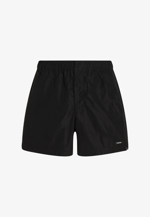 Schwarze Schwimmshorts mit einem elastischen Bund, glattem, wasserabweisendem Stoff und einem kleinen Logo-Akzent auf der unteren rechten Seite.