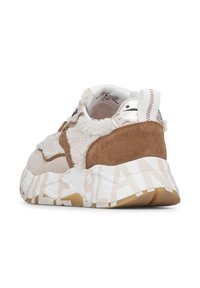 Chunky sneaker with beige suede, white shearling fabric, and white sole featuring large, light beige text wrapping around the heel.