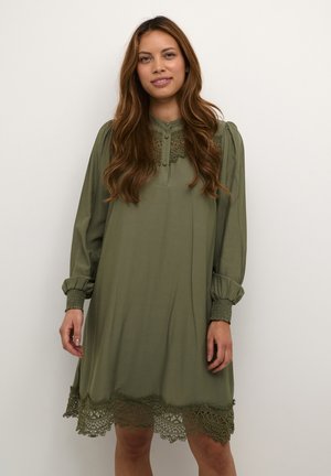 Olive green dress with a collared neckline, button closure, and long puff sleeves. Features intricate lace trim at the hem and elastic cuffs.