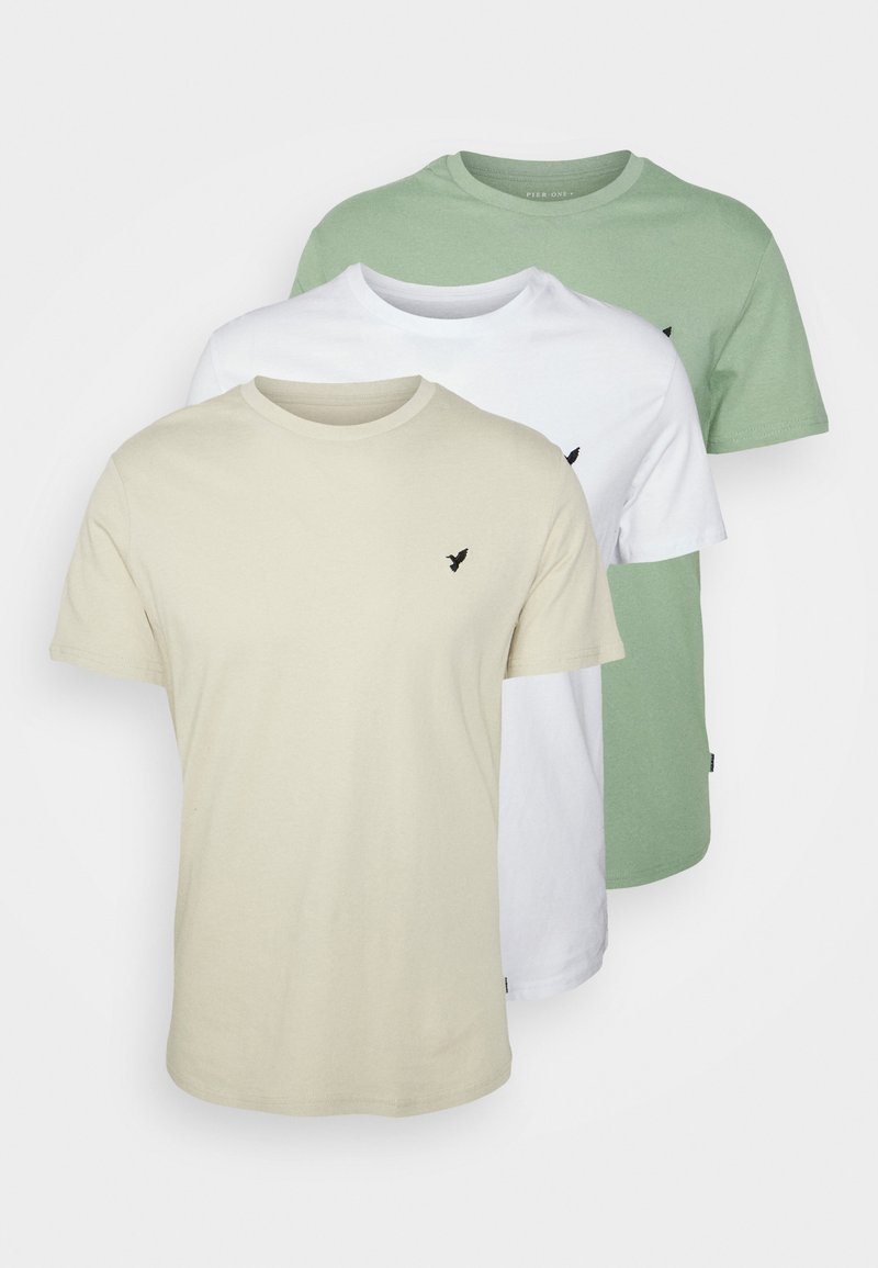 Set di tre t-shirt a manica corta con collo rotondo nei colori beige, bianco e verde. Realizzate in cotone, presentano un piccolo logo di un uccello nero sul petto.