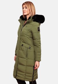 Olive green puffer coat with black faux fur hood, quilted texture, front zipper, two side pockets, and black accent details.