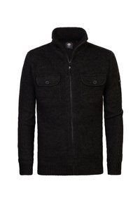 Svart zip-up kofta tillverkad av texturerat stickat tyg, med två bröstfickor och hög krage. Minimalistisk design utan några ytterligare mönster.