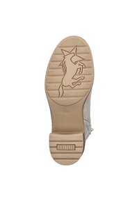 Semelle de chaussure beige avec une finition en caoutchouc texturé. Présente un motif de licorne en relief et la marque "MUSTANG" embossée sur le talon.