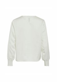 Vit långärmad blus med smockade manschetter och en liten nyckelhålsknapp stängning i nackdelen.