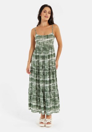 Green and white tiered maxi dress with spaghetti straps, featuring a tie-dye pattern and a relaxed fit, made from soft fabric.