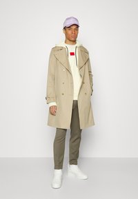 HUGO DARATSCHI - Sweatshirt com capuz - light pastel yellow