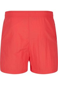 Red, lightweight swim shorts with an elastic waistband. Simple design, smooth texture, no patterns or hardware details.