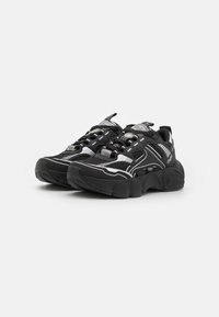 Black athletic shoes with mesh upper, rubber sole, reflective stripes, padded tongue, and textured detailing on the sides.
